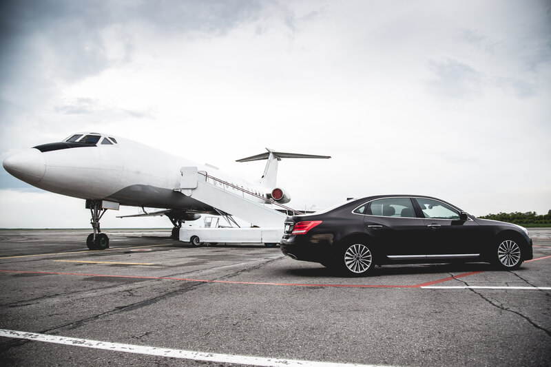 Mini saloon beside private jet luxury chauffeur services