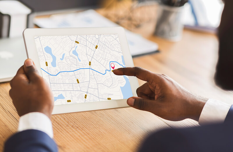 man pointing at google maps on ipad